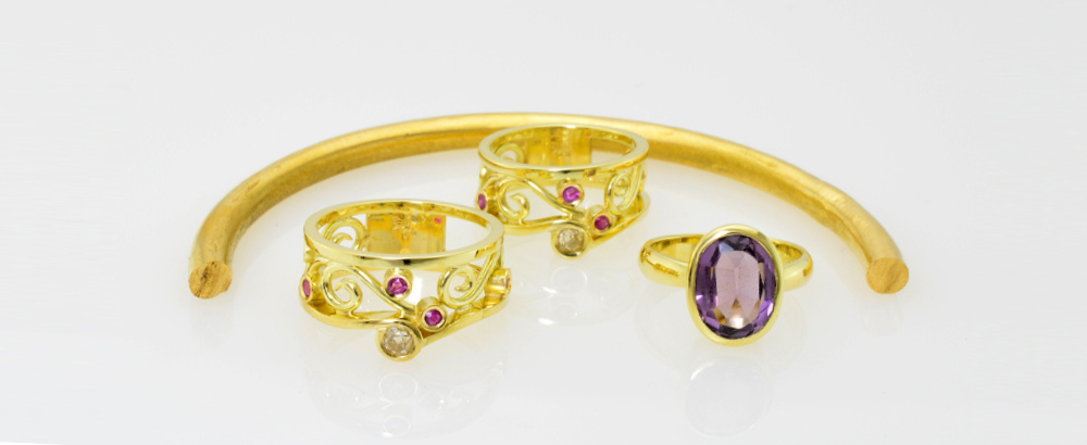 Two Sisters Separated by Distance connected by matching rings from gold from their homeland