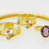 Two Sisters Separated by Distance connected by matching rings from gold from their homeland