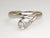 Platinum band ring with pear shape diamond rub over set.