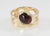 9ct yellow gold ring with large openings and oval cabochon Garnet