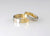 2 tone wedding bands in 18ct yellow and 18ct white gold. band is half white half yellow gold. 1 band has small princess cut diamond set into the band