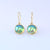 9ct yellow gold drop earrings with Eyris blue round pearls in rub over setting 