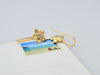 9ct yellow gold manuka drop earrings with white gold center on size sample
