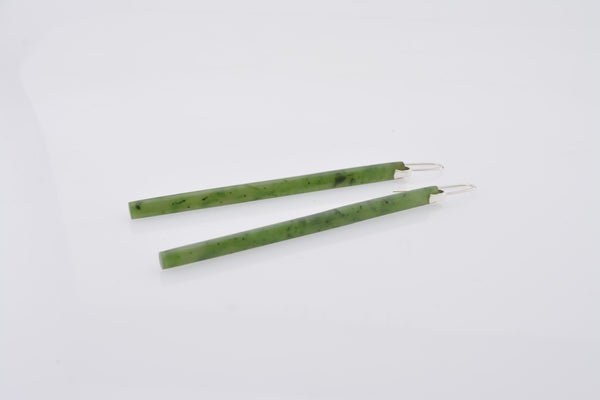 Green earrings on a white background