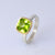 sterling silver ring with large cushion peridot in 9ct yellow gold rub over setting