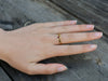 Ring gold celtic design with ruby on model