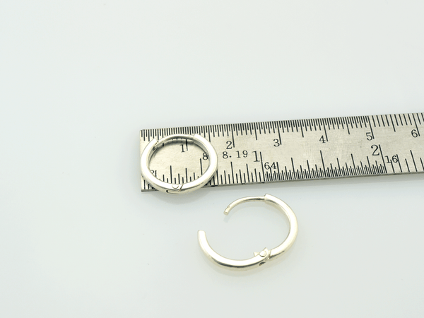 handmade silver hoops on ruler