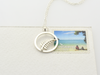 silver fern circle pendant size reference on a kiwi stamp