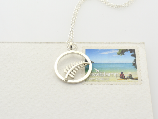 silver fern circle pendant size reference on a kiwi stamp