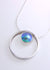 sterling silver ring sliding on a chain with an Eyris blue pearl rub over set in the center sliding