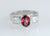 18ct white gold ladies dress ring with oval rhodolite garnet and princes cut white sapphires.