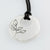 large solid disc with leaf engravings in sterling silver on leather cord