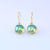 9ct yellow gold drop earrings with Eyris blue round pearls in rub over setting