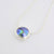 Eyris blue pearl in a clean simple rub over setting sliding on a sterling silver chain