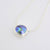 Eyris blue pearl in a clean simple rub over setting sliding on a sterling silver chain