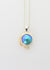 sterling silver pendant with Eyris blue pearl in a rub over setting. the setting is surrounded with a 9ct yellow gold wire with a diamond set at the end of the wire