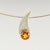 Sterling silver pendant with Yellow Citrine set in 9ct gold. the omega chain runs through the pendant shape