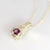Sterling silver pendant with chain running through the pendant. Rhodolite garnet set in rub over setting