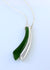 greenstone/ Pounamu curved bar elegant sitting besides an identical sterling silver bar hanging freely on a sterling silver chain