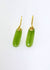 Long oval pounamu domed shaped earrings hanging from 9ct yellow gold earring with koru design