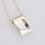 large rectangle block pendant with long oval cut out set with Black Diamond
