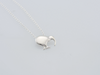 A silver pendant necklace featuring a minimalist kiwi bird pendant on a delicate silver chain, photographed against a clean, light gray background.