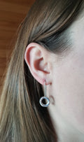 Model wearings Sterling Silver Möbius drop earrings